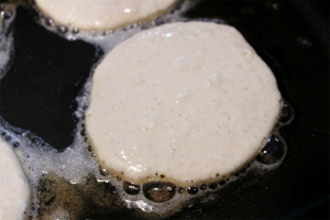 Diner Style Pancake on a griddle sizzling in butter