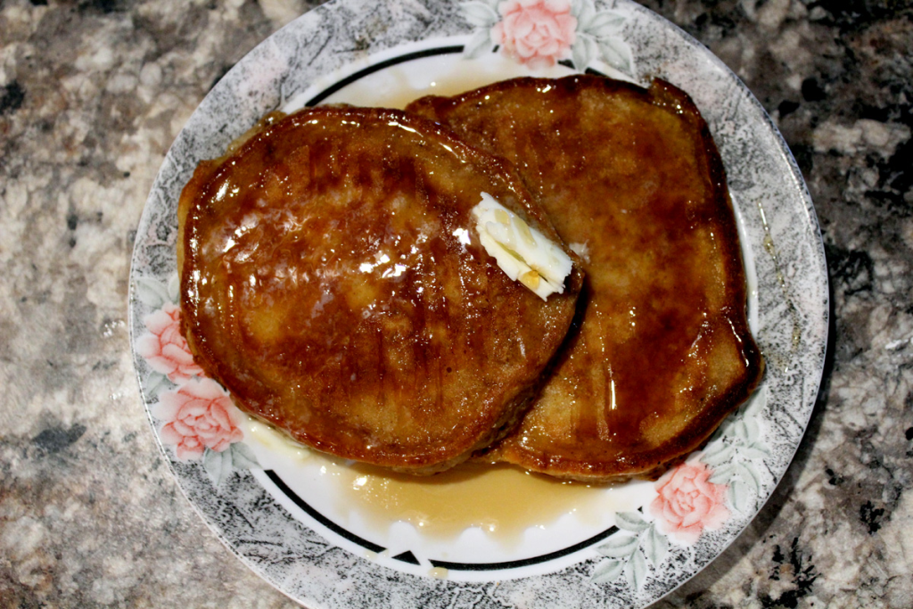 Overhead shot of diner style pancakes wit crispy edges on a plate