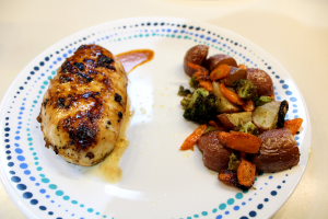 Lemon garlic chicken with roasted potatoes, carrots, and broccoli on a plate