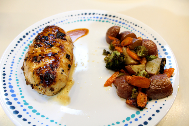 Lemon garlic chicken with roasted potatoes, carrots, and broccoli on a plate