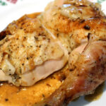 Close up of Herb Roasted Chicken, with juices on the plate