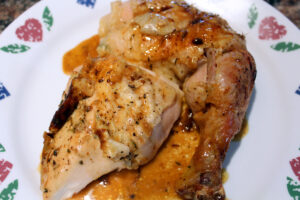 Herb Roasted Chicken with juices on the plate