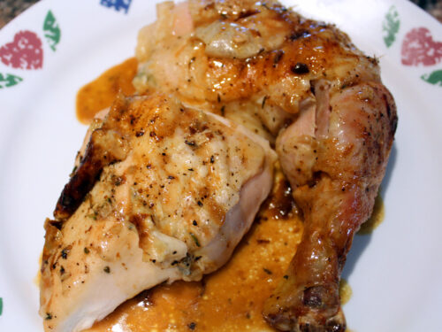 Herb Roasted Chicken with juices on the plate