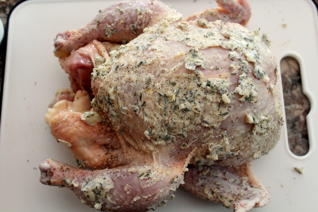 top view of a Whole chicken covered with herb butter