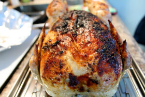 Close up of a Whole Herb Roasted Chicken Fresh Out the Oven with beautifully charred skin