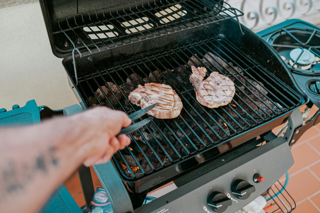 Close-up of two steaks grilled on a gas grill