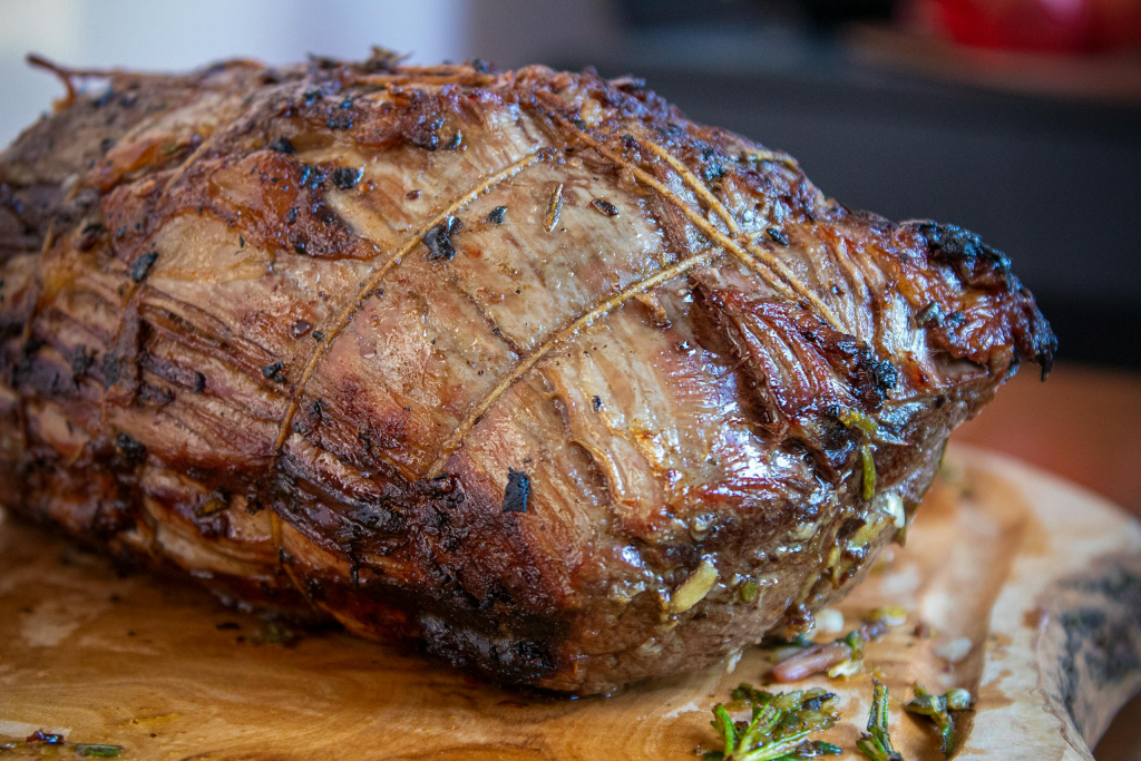 Deliciously roasted beef seasoned with herbs resting after being cooked.