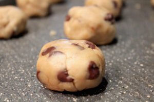 Close up of Brown Butter Chocolate Chip Cookie Dough Balls on a tray