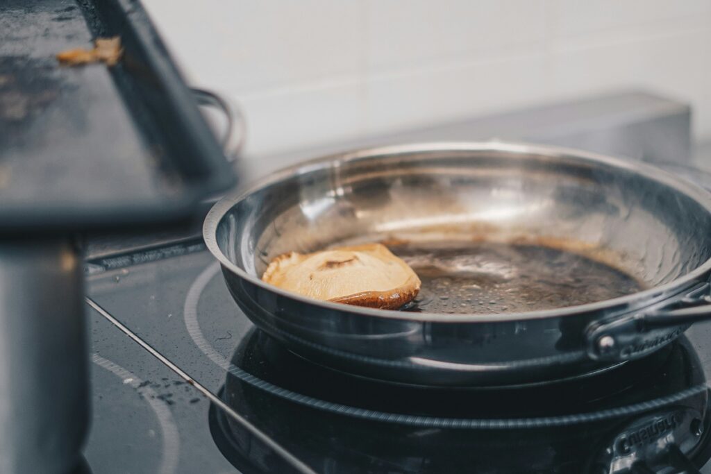 Stainless Steel Pan being used to cook in a kitchen